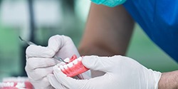 A dental technician slowly making dentures