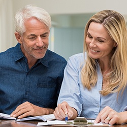 Man and woman reviewing dental insurance policies