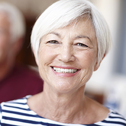 Elderly lady with striped shirt smiling