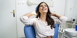 Woman relaxing with hands behind head in dental chair