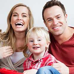 Denton Preventive Dentistry Family of three smiling