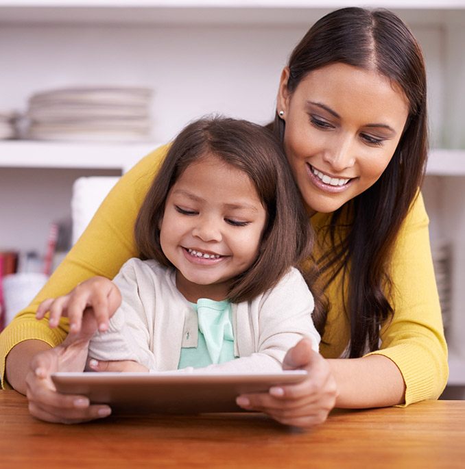 Mother and daughter playing with tablet